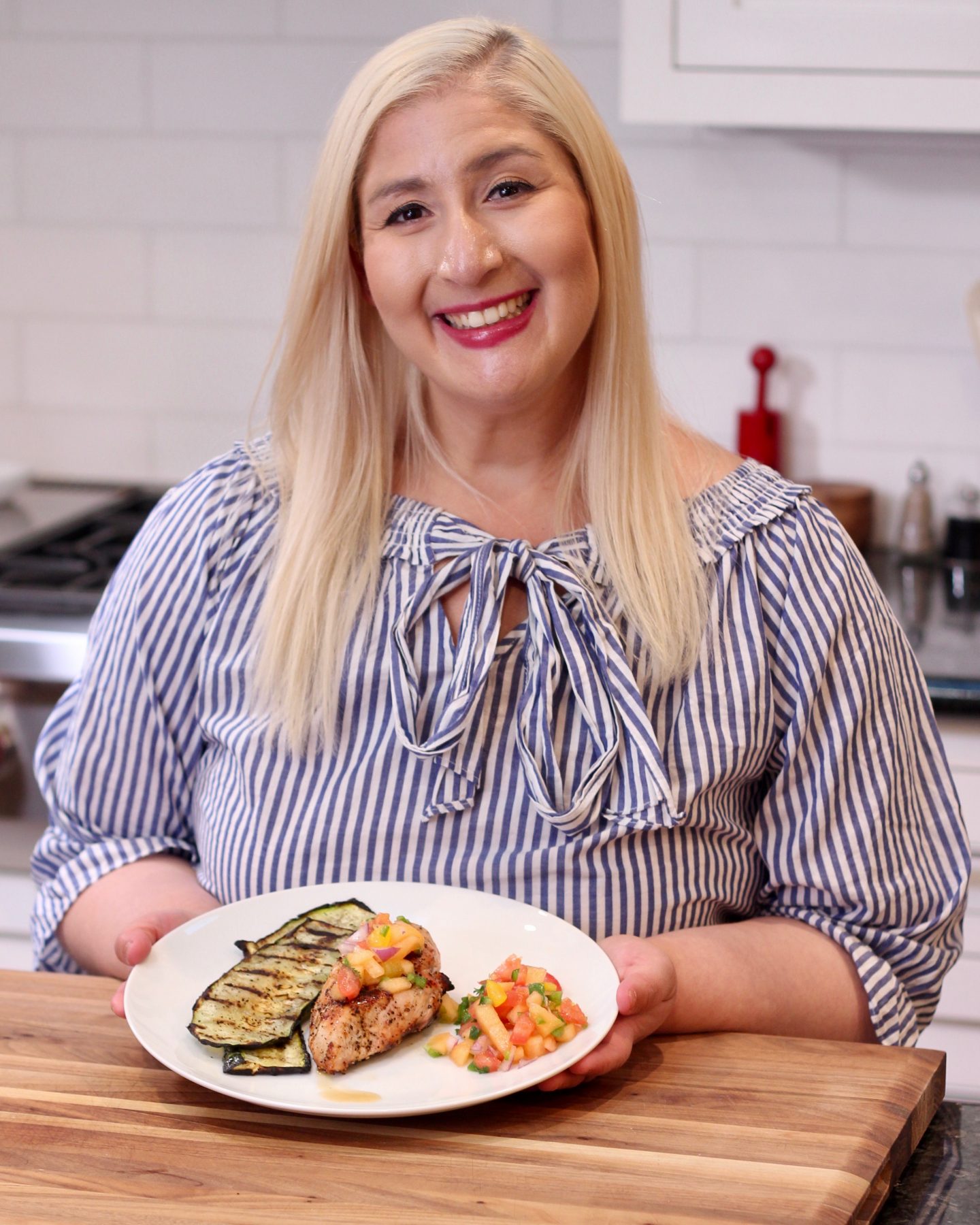 Jacqueline Holding plate with chicken, cantaloupe salsa and zucchini