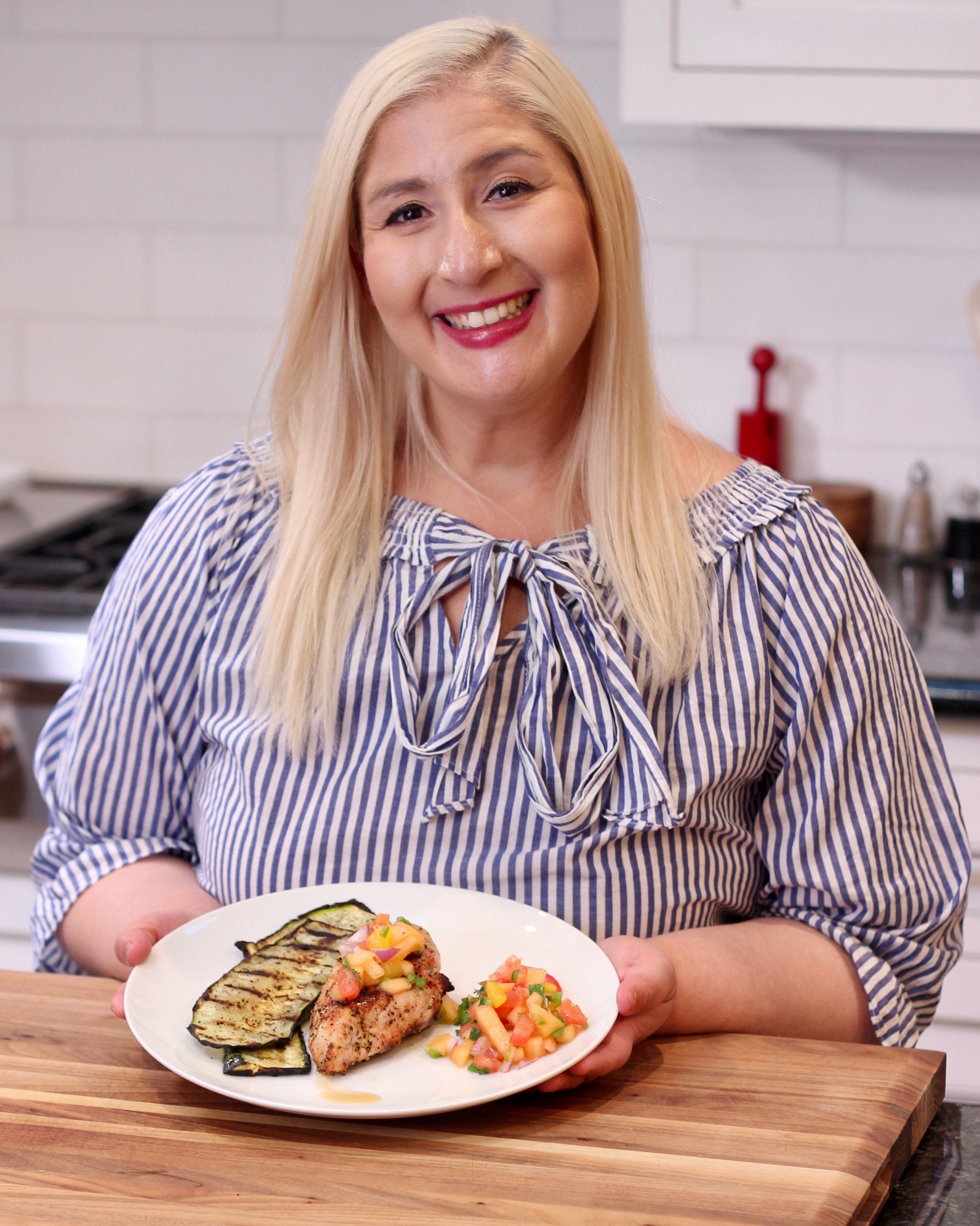 Jacqueline Holding plate with chicken, cantaloupe salsa and zucchini